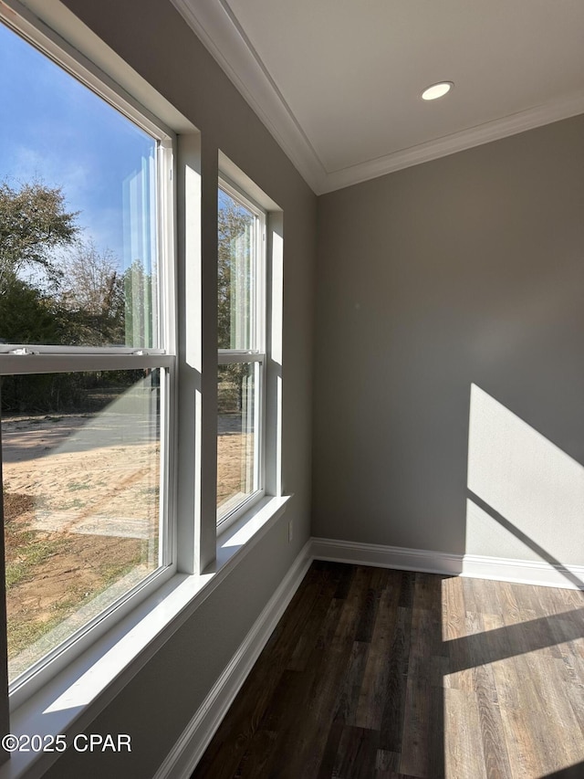 empty room with dark wood-type flooring, crown molding, recessed lighting, and baseboards