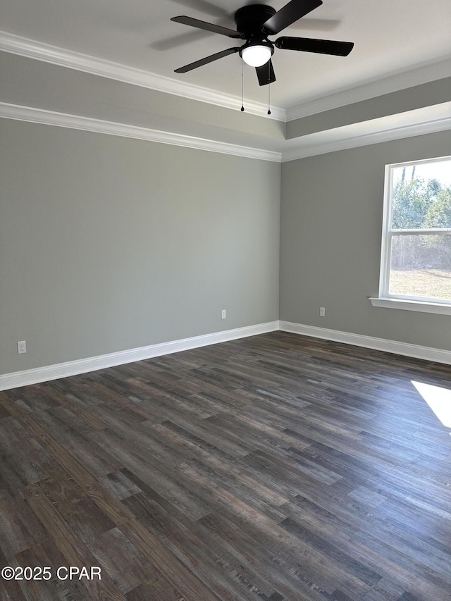 unfurnished room featuring ornamental molding, a ceiling fan, dark wood-style flooring, and baseboards