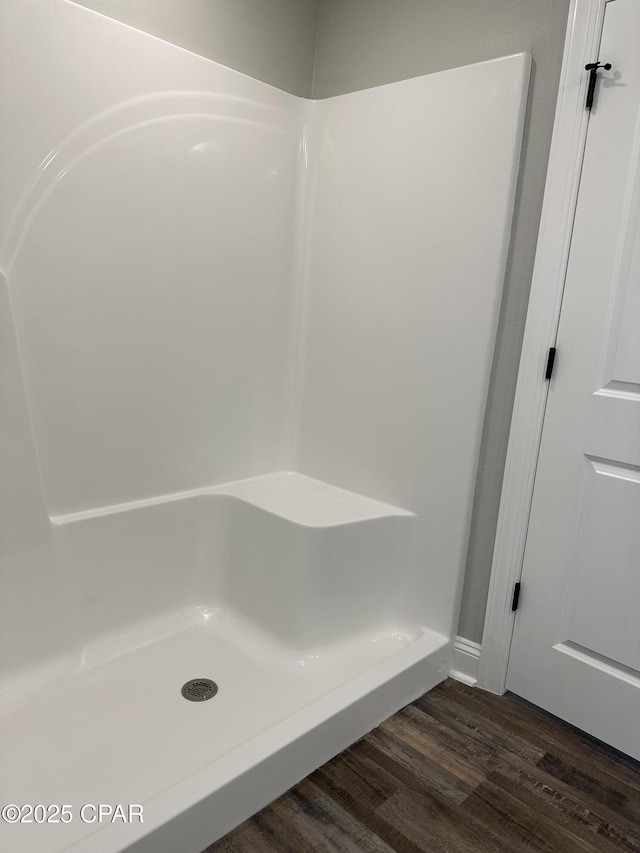 bathroom with a shower and hardwood / wood-style flooring