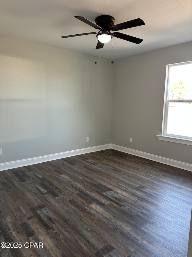 spare room with ceiling fan and dark wood-type flooring