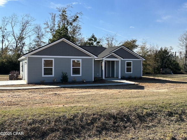 single story home with a front yard and a garage