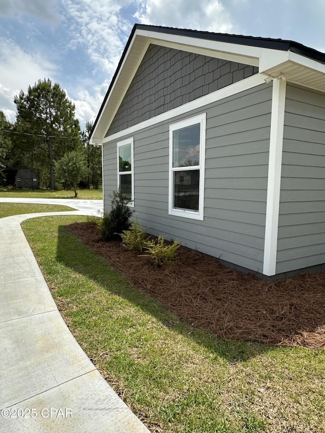 view of home's exterior with a yard