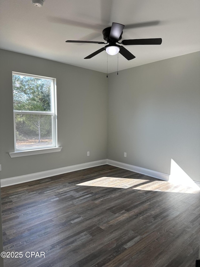 empty room with ceiling fan and dark hardwood / wood-style floors