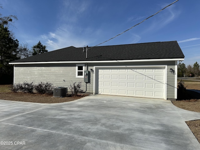 view of home's exterior with a garage and cooling unit