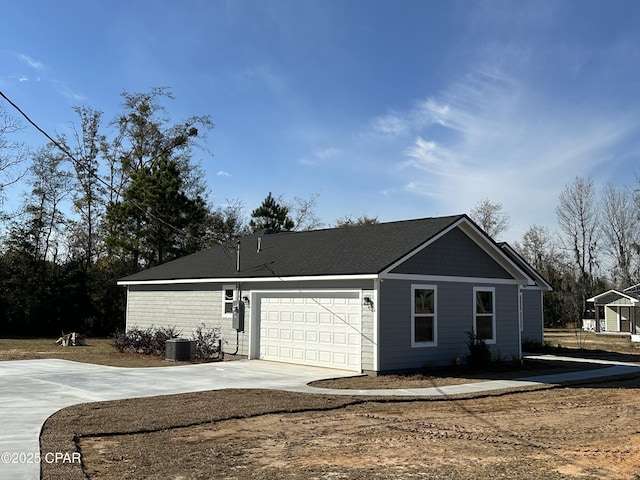 view of front facade featuring a garage and cooling unit