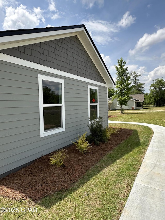 view of property exterior featuring a lawn