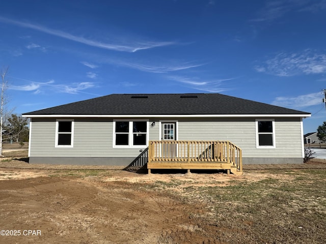 back of house featuring a wooden deck