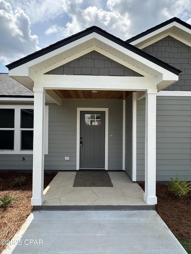 doorway to property featuring covered porch