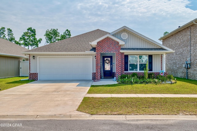 view of front of property with a garage and a front lawn