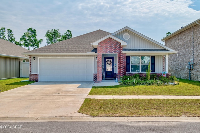 view of front of property featuring a garage and a front lawn