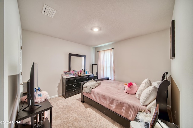 carpeted bedroom featuring a textured ceiling