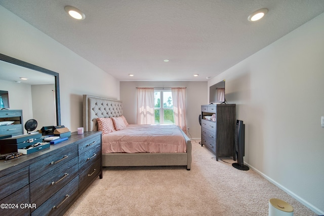 carpeted bedroom featuring a textured ceiling