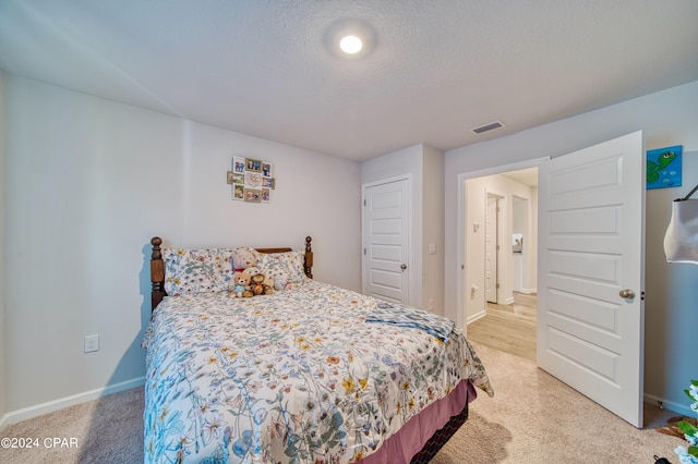 carpeted bedroom featuring a textured ceiling