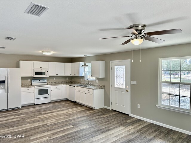 unfurnished living room featuring a textured ceiling, hardwood / wood-style flooring, ceiling fan, and sink