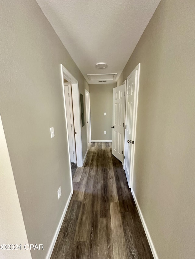 hall featuring dark hardwood / wood-style floors and a textured ceiling