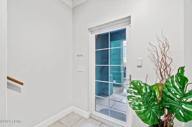 doorway to outside with light tile patterned floors