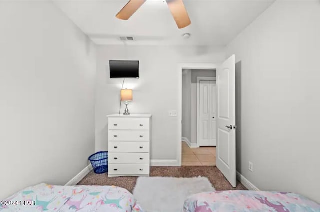 tiled bedroom with ceiling fan