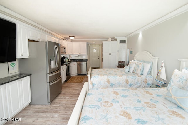 bedroom with light hardwood / wood-style floors, stainless steel fridge, sink, and ornamental molding