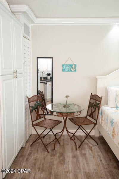 living area featuring hardwood / wood-style floors and ornamental molding