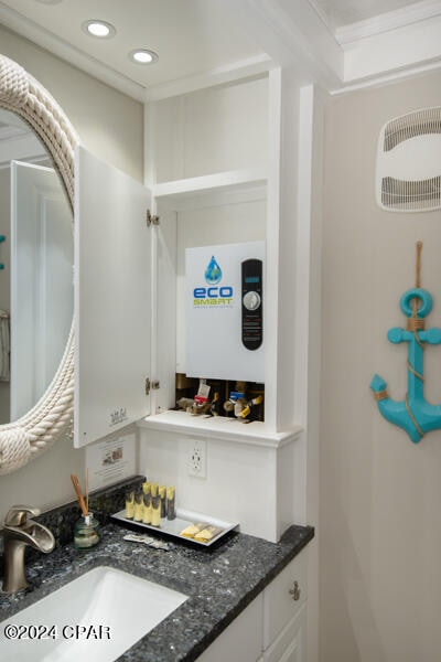 bathroom featuring crown molding and vanity