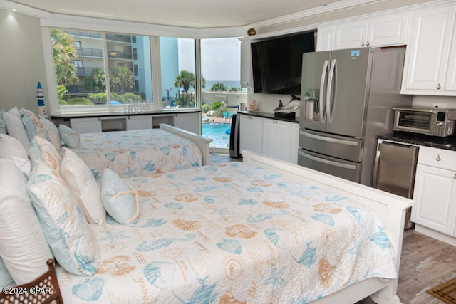 bedroom with access to outside, crown molding, wood-type flooring, and fridge