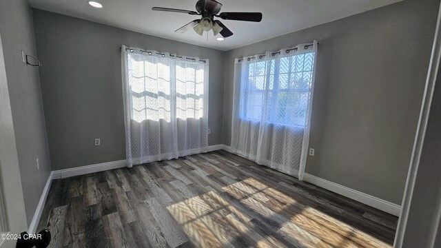 empty room featuring hardwood / wood-style flooring and ceiling fan