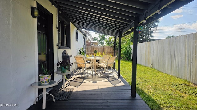 wooden deck featuring a yard