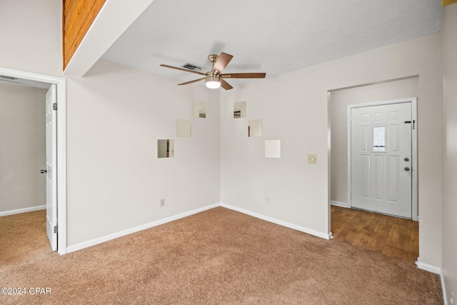 unfurnished living room with ceiling fan and carpet flooring