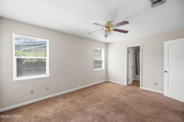 carpeted empty room with a textured ceiling and ceiling fan