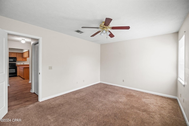 spare room featuring carpet and ceiling fan