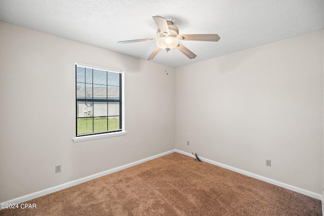 unfurnished room with a textured ceiling, carpet, and ceiling fan