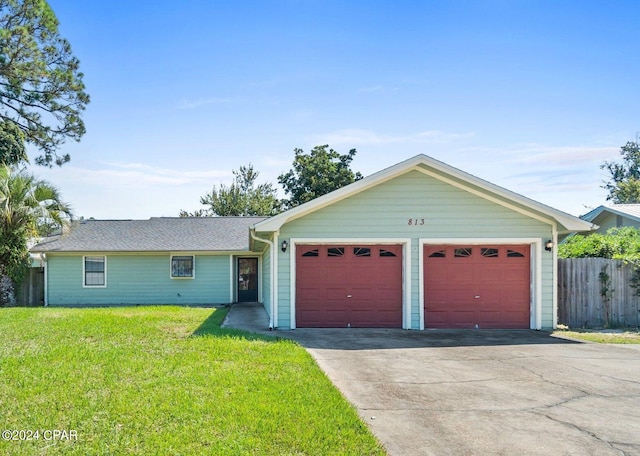 ranch-style home featuring a garage, concrete driveway, fence, and a front lawn
