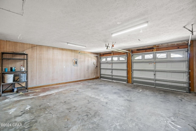 garage featuring wooden walls and electric panel