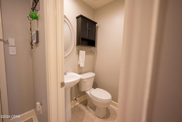 bathroom featuring toilet and tile patterned floors