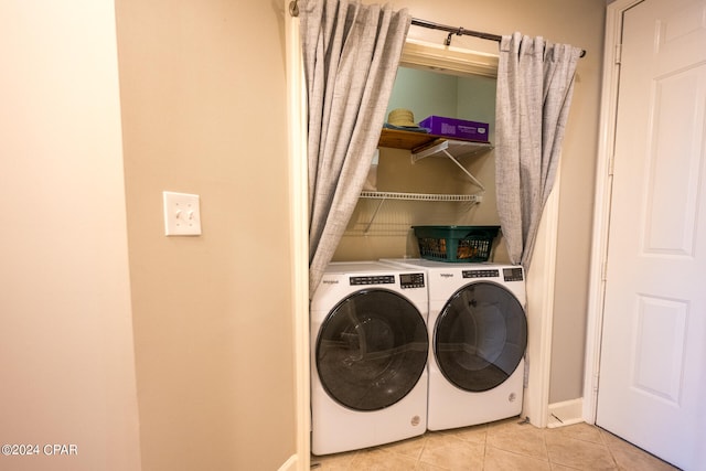 washroom featuring light tile patterned flooring and washing machine and dryer