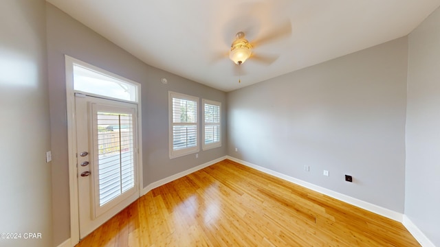 doorway to outside with ceiling fan and light wood-type flooring