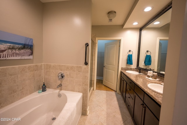 bathroom with tile patterned flooring, double vanity, and independent shower and bath