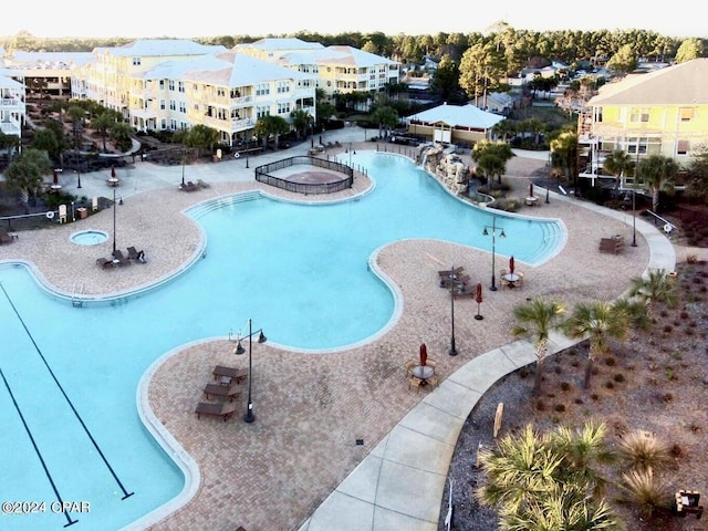 view of pool featuring a community hot tub and a patio area