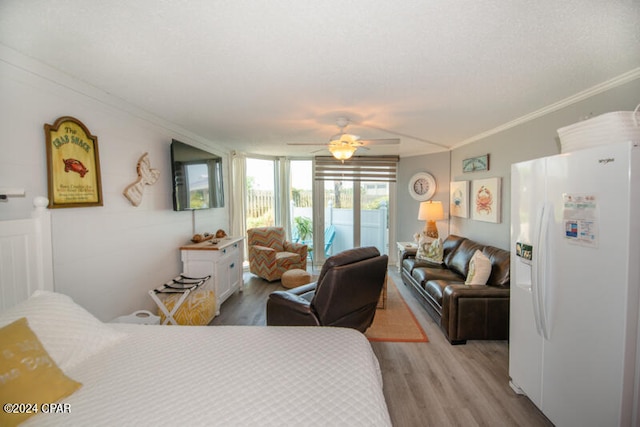 bedroom featuring white refrigerator with ice dispenser, hardwood / wood-style floors, access to outside, crown molding, and ceiling fan