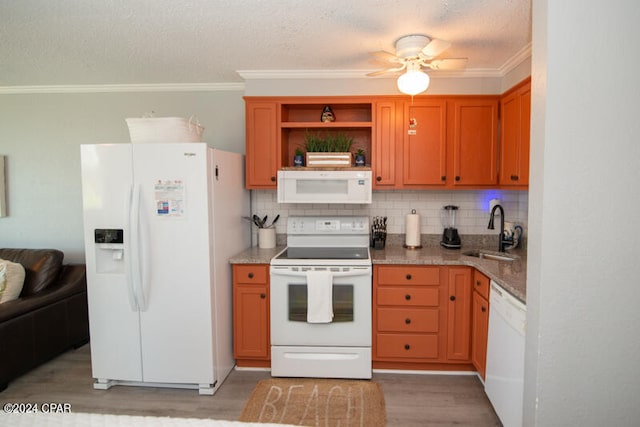 kitchen with crown molding, light wood-type flooring, white appliances, sink, and ceiling fan