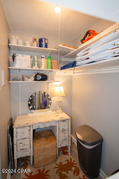 interior space featuring a textured ceiling and toilet