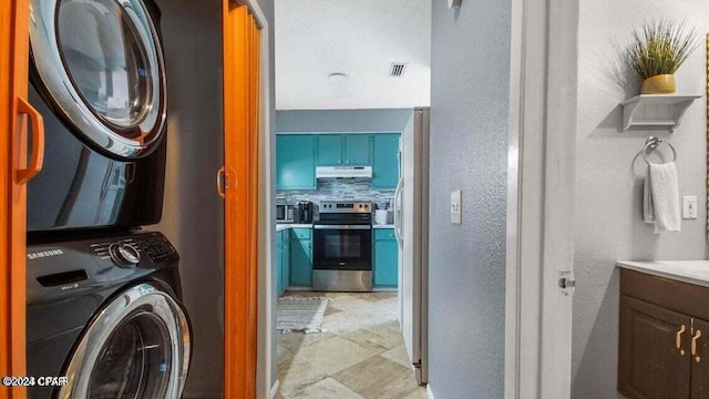 laundry room with stacked washer / dryer