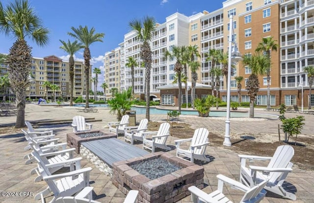 view of patio / terrace with an outdoor fire pit and a community pool