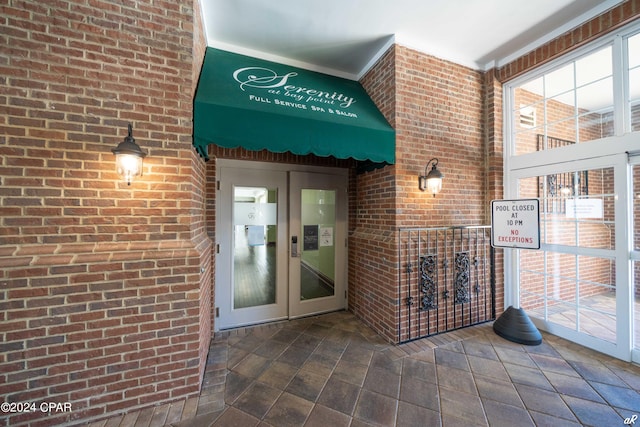 view of exterior entry featuring french doors