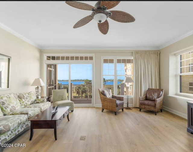 living room featuring a wealth of natural light, light hardwood / wood-style flooring, and ornamental molding