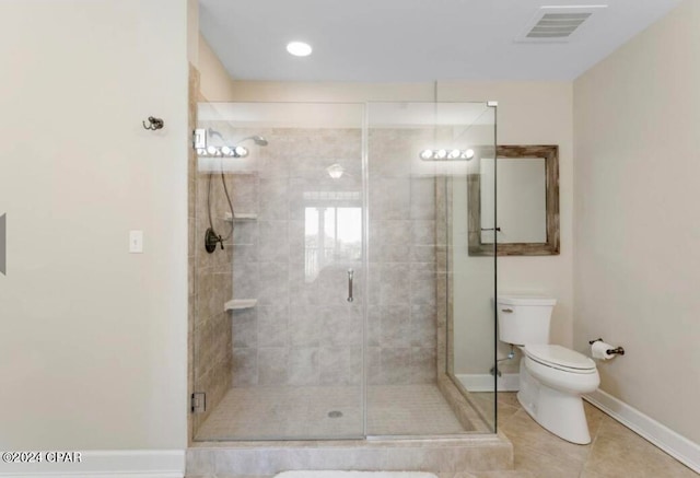 bathroom with toilet, a shower with door, and tile patterned floors