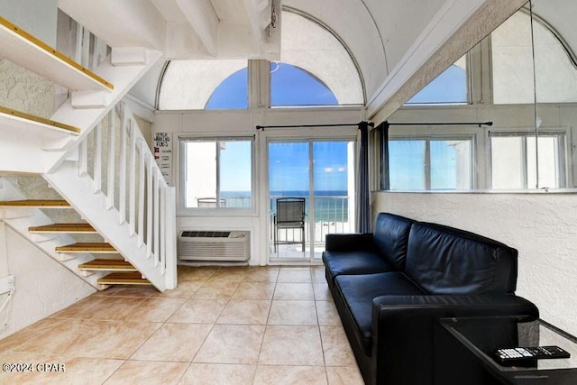 living room with light tile patterned flooring and a towering ceiling