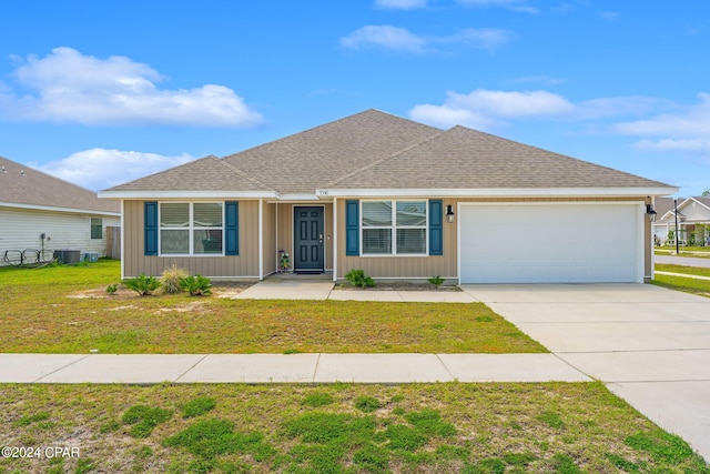 single story home with a garage and a front lawn