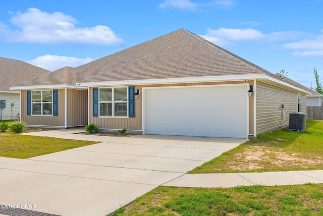 single story home with a garage, central AC, and a front yard