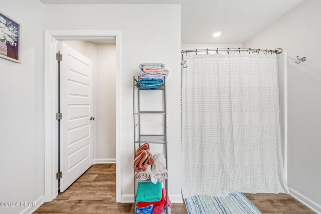 bathroom with wood-type flooring